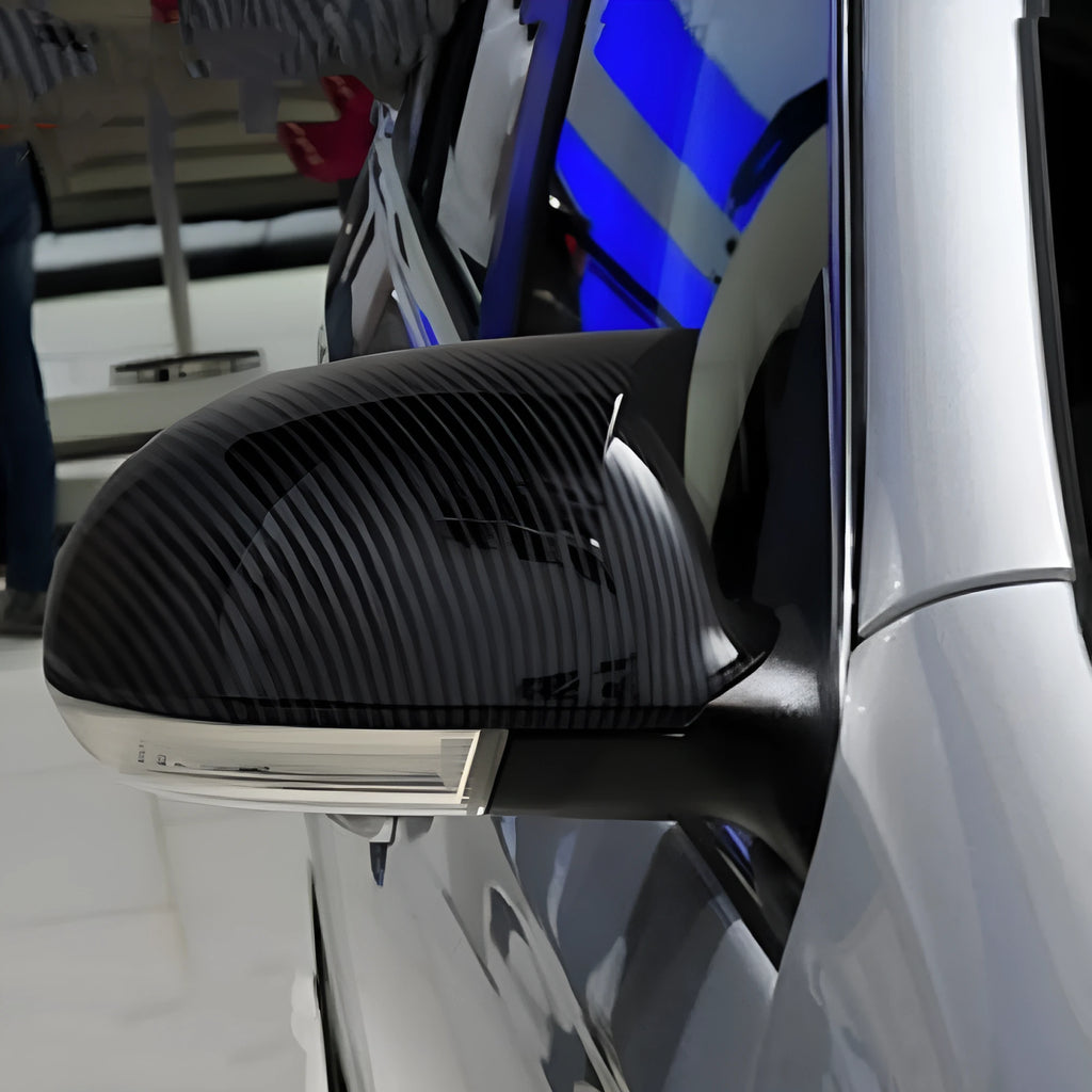 Pair of plastic outer reflector shells for Volkswagen Sagitar side mirrors in carbon fibre or bright black finish.