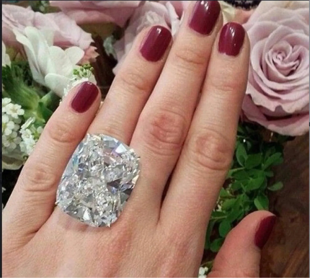 Women's simple white gold colour alloy ring with a square diamond inlay, shown on a finger.