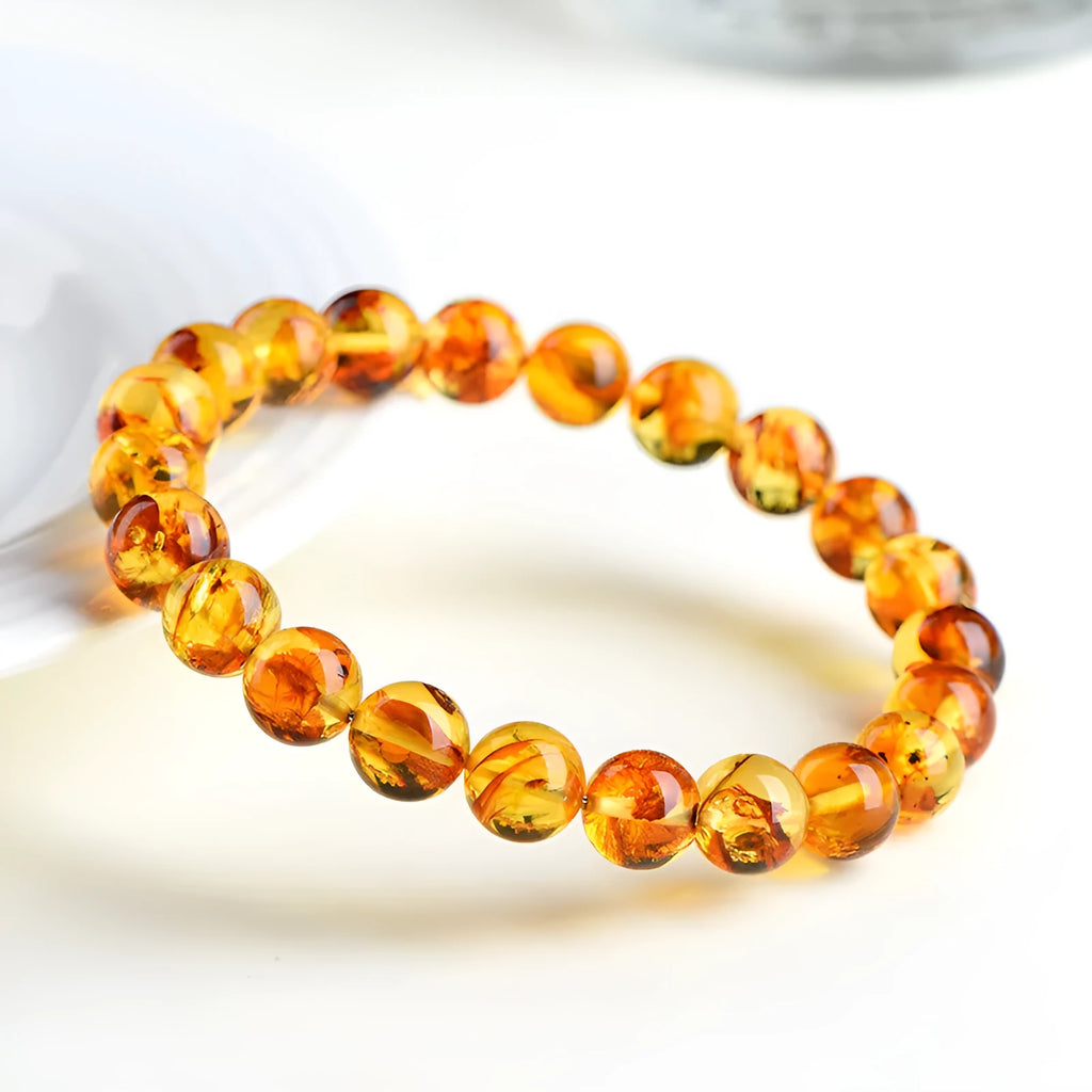 A geometric bead bracelet made from natural yellow piebald amber with flower spot patterning.