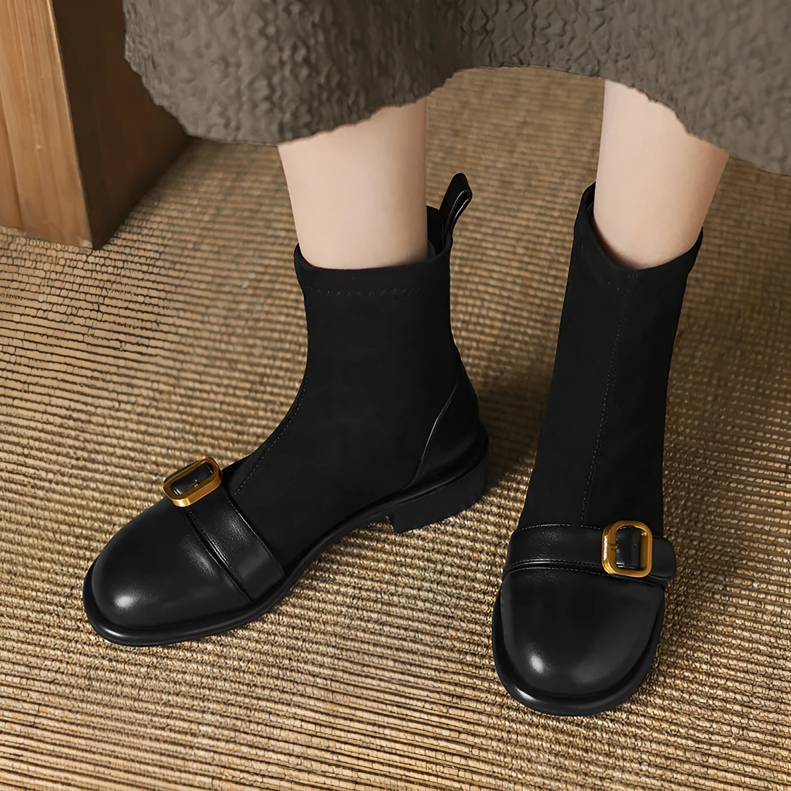 Women's black low-heel Martin ankle boots with buckle stitching and lace-up front.