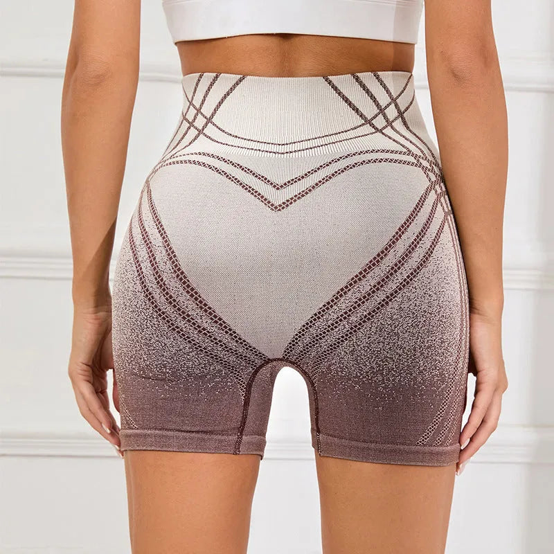 Women's high waisted gradient fitness shorts in black, shown for yoga or running.