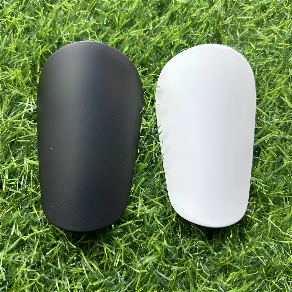 Extra small mini football shin guards measuring 8x5cm in black and white plastic construction