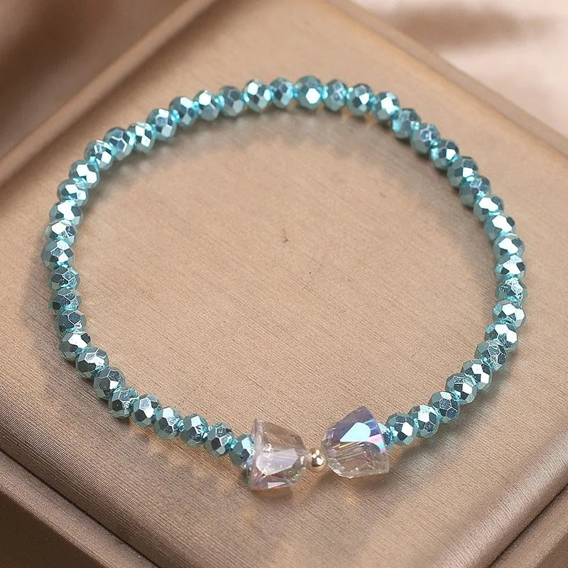 Colourful artificial crystal butterfly bracelet in blue, dark pink, and light pink, handcrafted with ethnic style for women