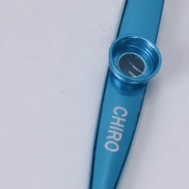 Metal kazoo in Flame Red with paper tube against a white background