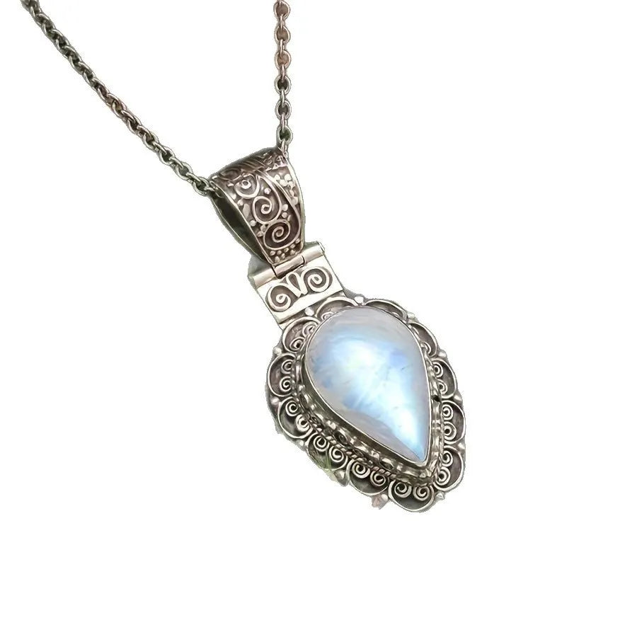 Silver heart-shaped moonstone drop necklace on a white background