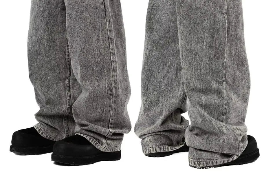 Grey loose-fit straight-leg cotton denim trousers on a mid-waist, shown from the front.