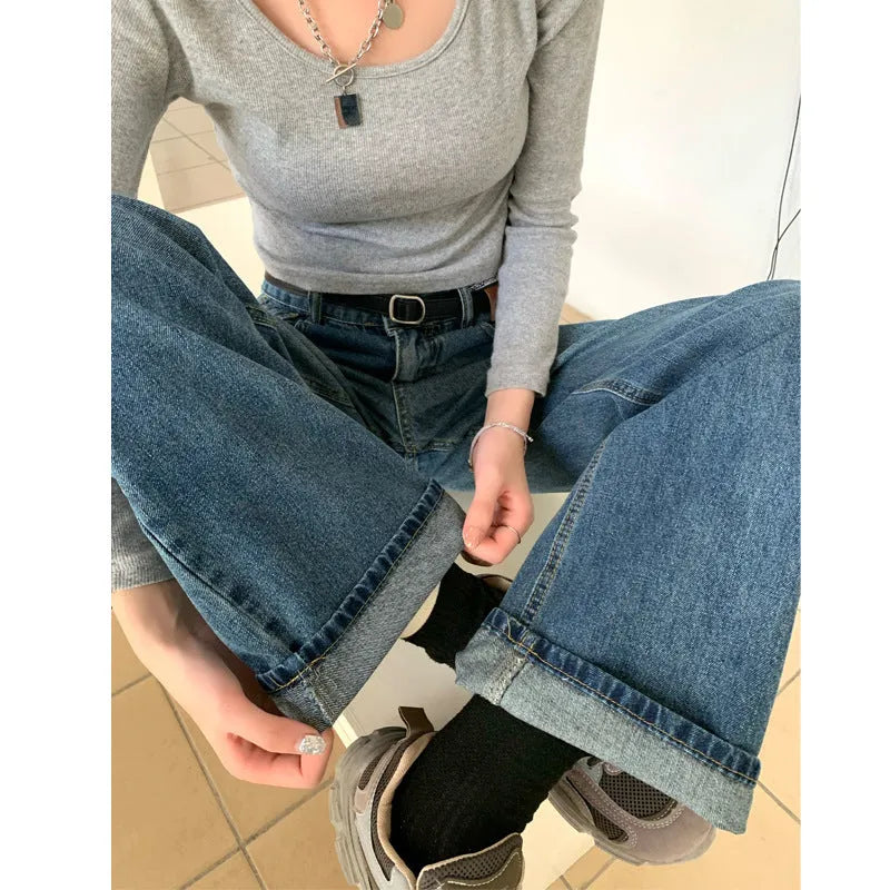 Women's high waist straight leg jeans in a retro blue wash, showcasing the denim fabric and cut.