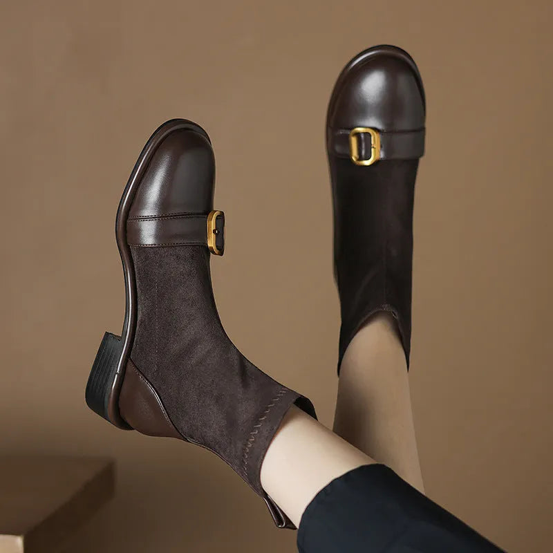 Women's black low-heel Martin ankle boots with buckle stitching and lace-up front.
