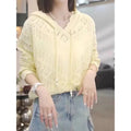Woman wearing a light blue crochet hollow hooded longsuit undershirt with long sleeves.