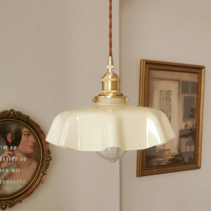 Medieval brass flower bud French chandelier with a glass body and adjustable chain.