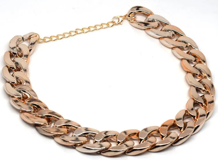 Gold chain dog collar necklace with a geometric buckle on a small dog