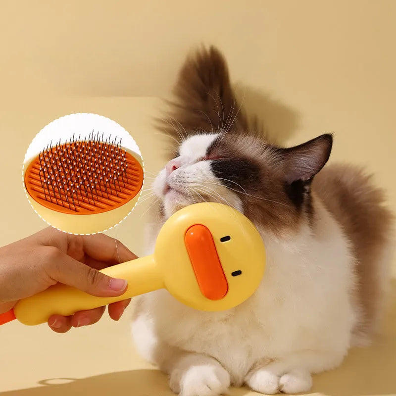 Small plastic pet comb with yellow duck design, showing open sections and floating needles for cat and dog grooming.