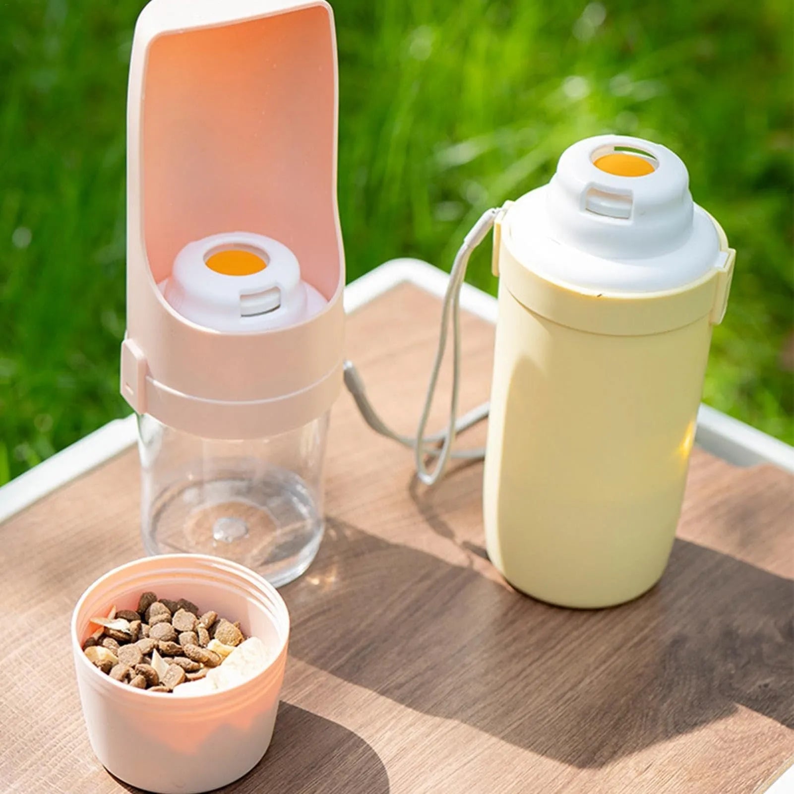Green 2-in-1 travel dog water bottle with lanyard, showing water dispenser and food container compartments.