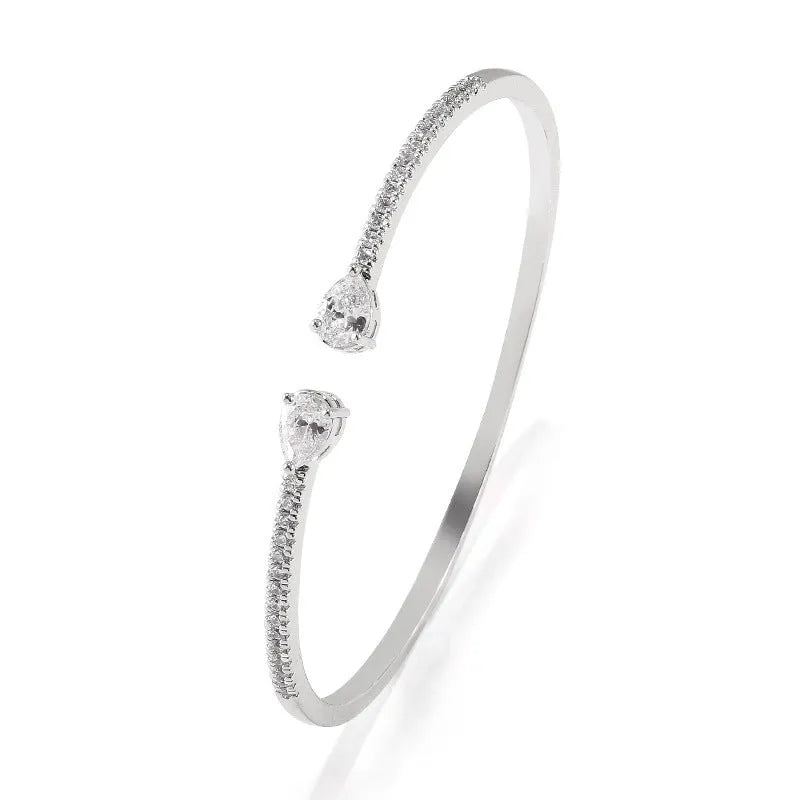 Copper bracelet with inlaid zircon stones in a simple design, shown in white and blue colour options.