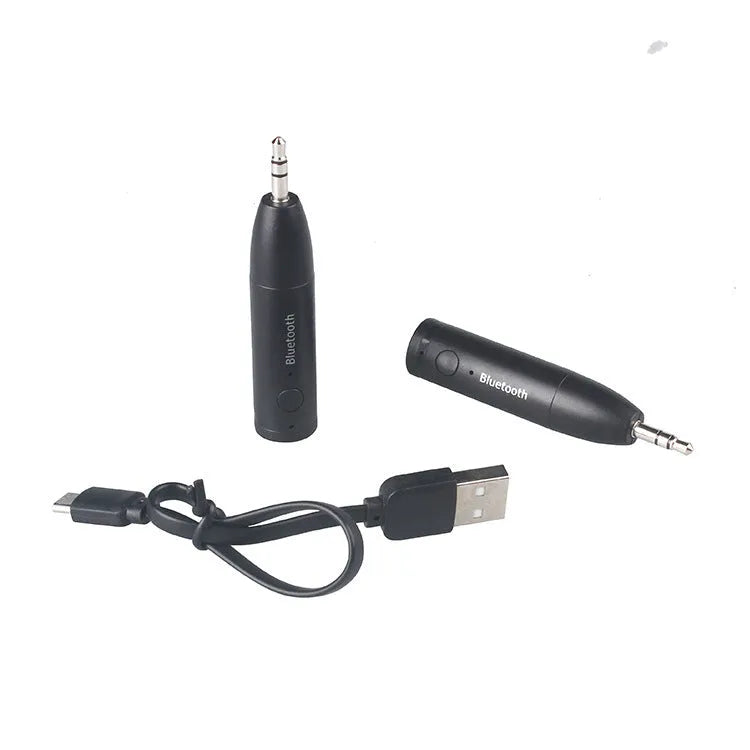 Black AUX Bluetooth 5.0 audio receiver for car stereo with USB cable.