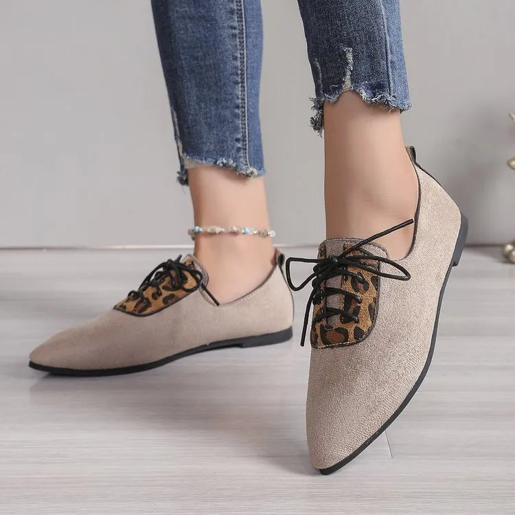 Beige leopard print women's pointed toe pumps on a white background, side view.