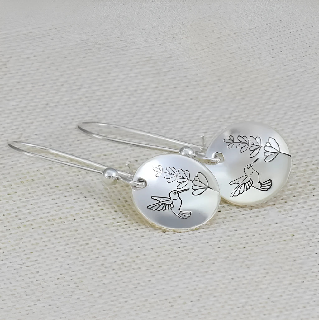 Silver zinc alloy women's earrings with bird and leaf design in circular retro style