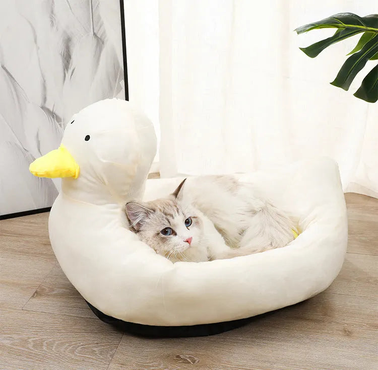 Blue duck-shaped fluffy pet bed for small dogs and cats on a floor