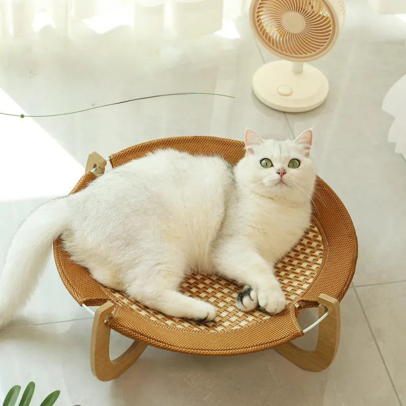 Brown woven rattan pet hammock bed for cats and small dogs on elevated stand