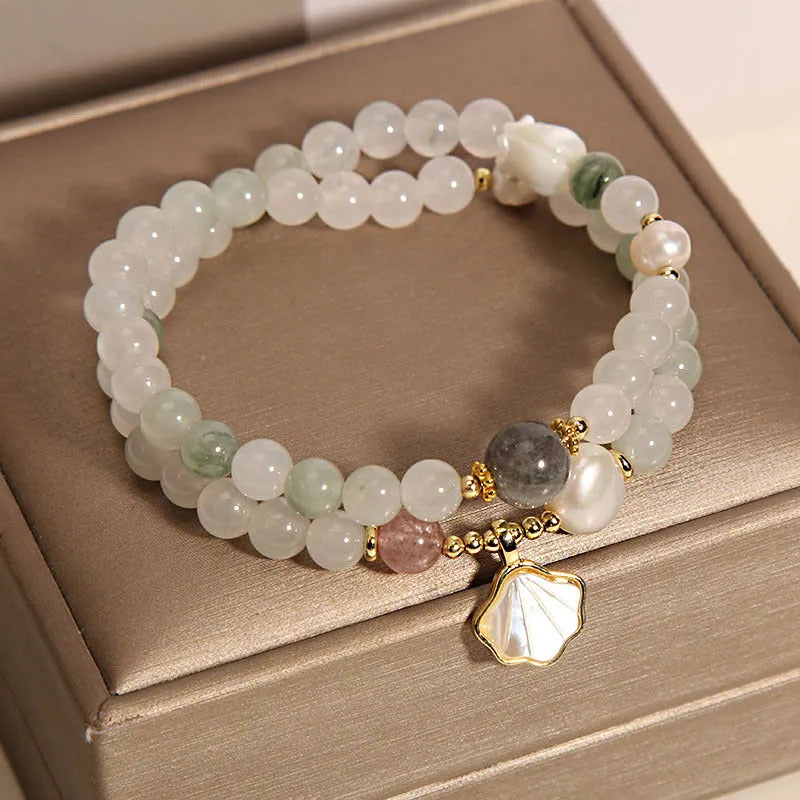 Women's crystal bracelet with gold-plated inlay, gemstones, and a Tianshan Jade ginkgo leaf pendant.