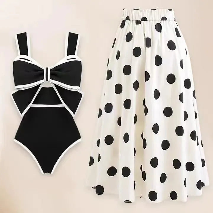 Women's black one-piece swimsuit with white round skirt and bow decoration on front