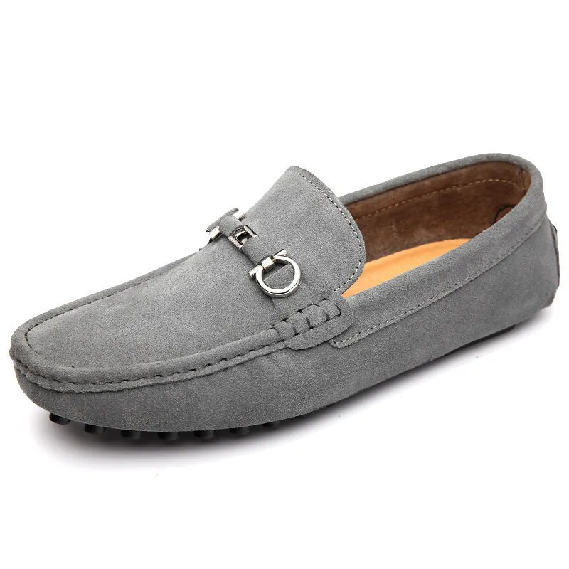 Men's black cowhide leather slip-on shoes with square toe and visible stitching on a rubber sole.