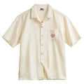 Light apricot men's shirt with bamboo floral pattern and Cuban collar on hanger