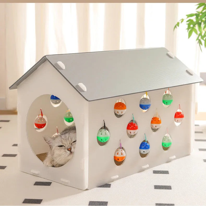 Plastic cat scratch board house with integrated tunnel containing bell ball and nest bed area