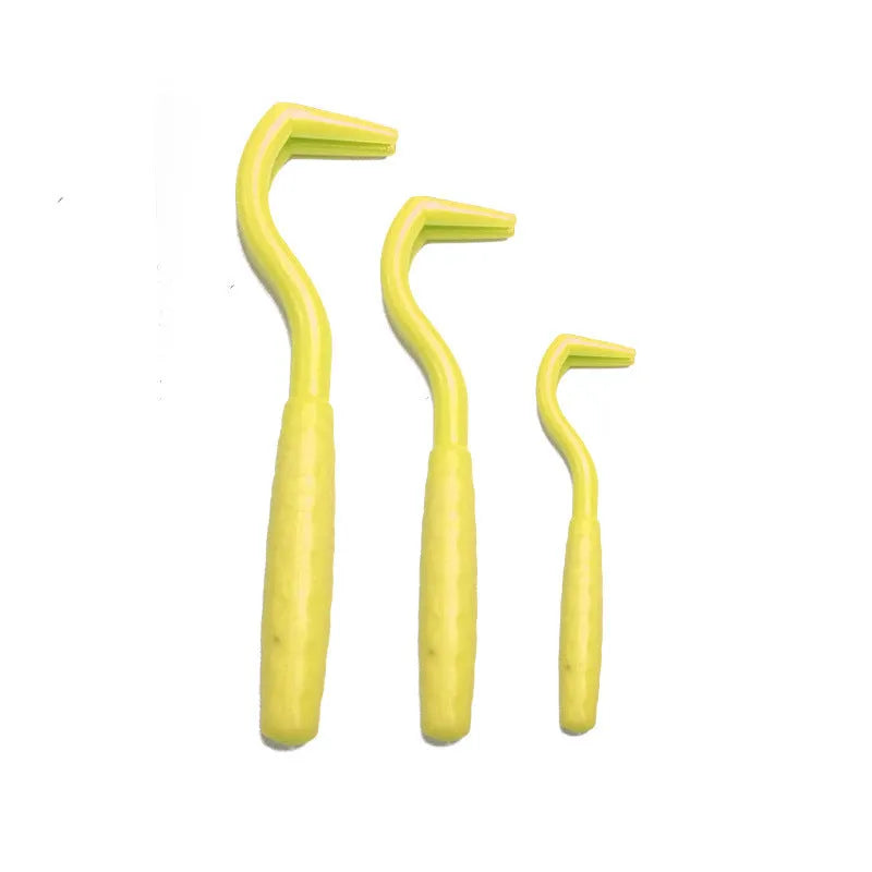 Three plastic tick removal hooks for dogs in assorted colours on a white background.