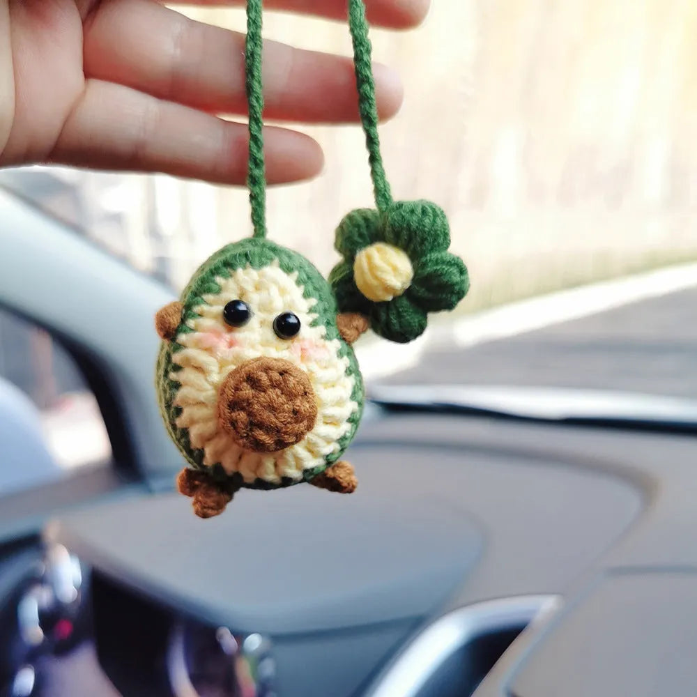 Handmade crocheted rainbow flower car pendant in wool yarn with avocado, pink, and red colour options