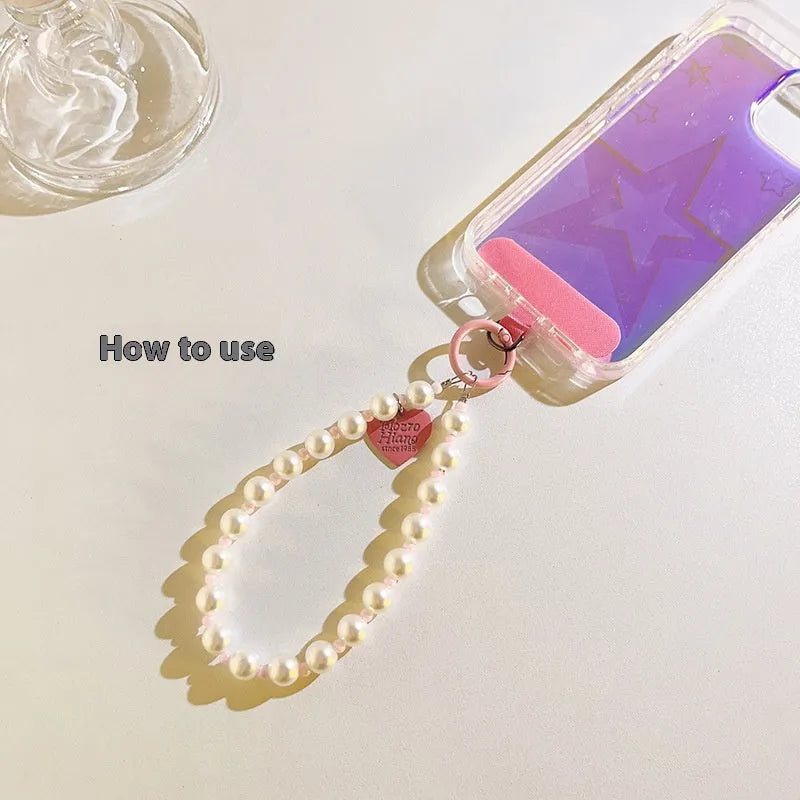 Pink pearl bead mobile phone lanyard with crossbody shoelace and wrist strap on white background