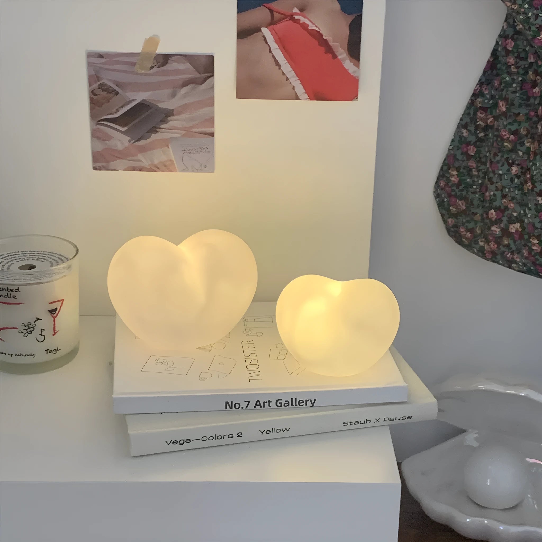 Small pink vinyl atmosphere lamp glowing with warm light on a wooden surface.