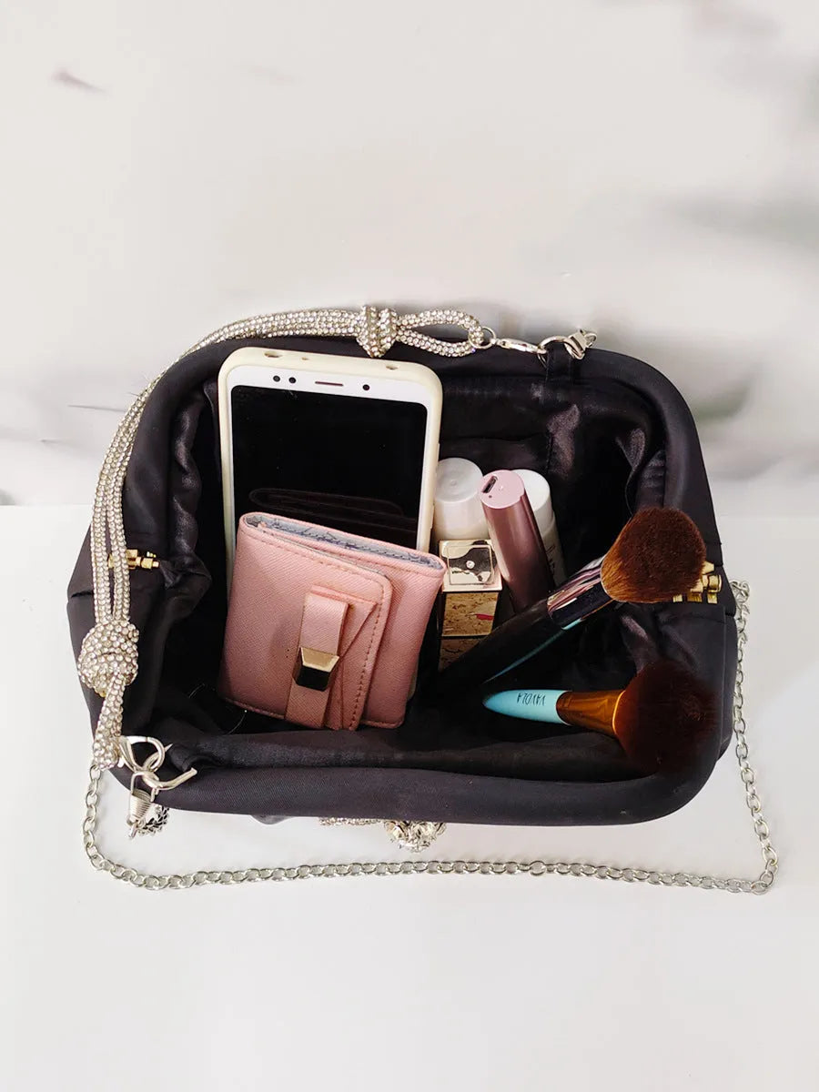 Women's soft shell-shaped polyester messenger bag in black with decorative chain and diamond details