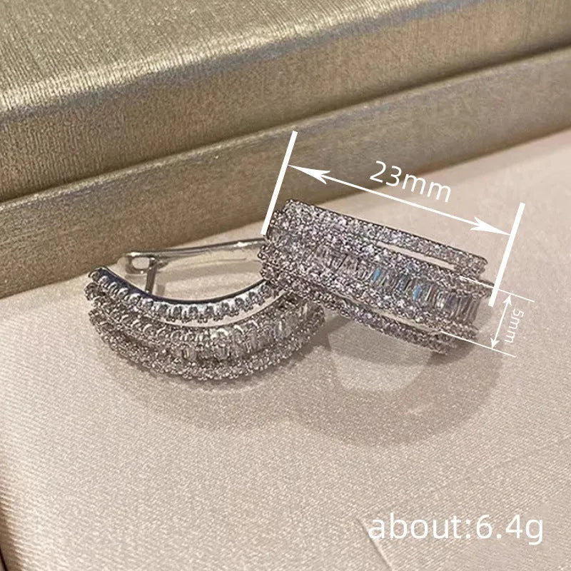 Women's geometric zircon stud earrings with white gold colour plating.