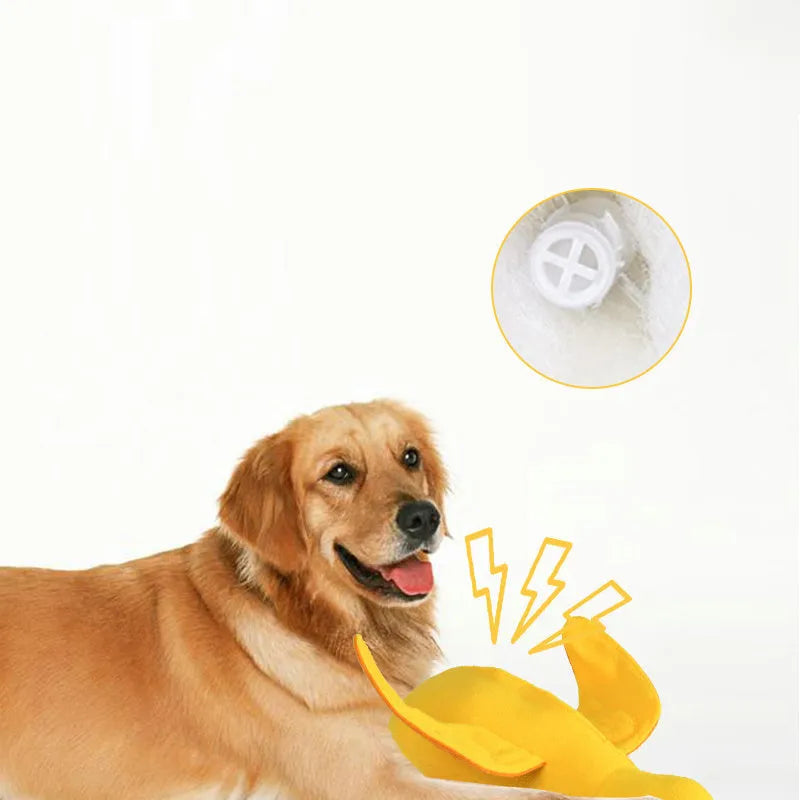 Yellow plush duck dog toy with squeaker and treat-dispensing feature for training and play.