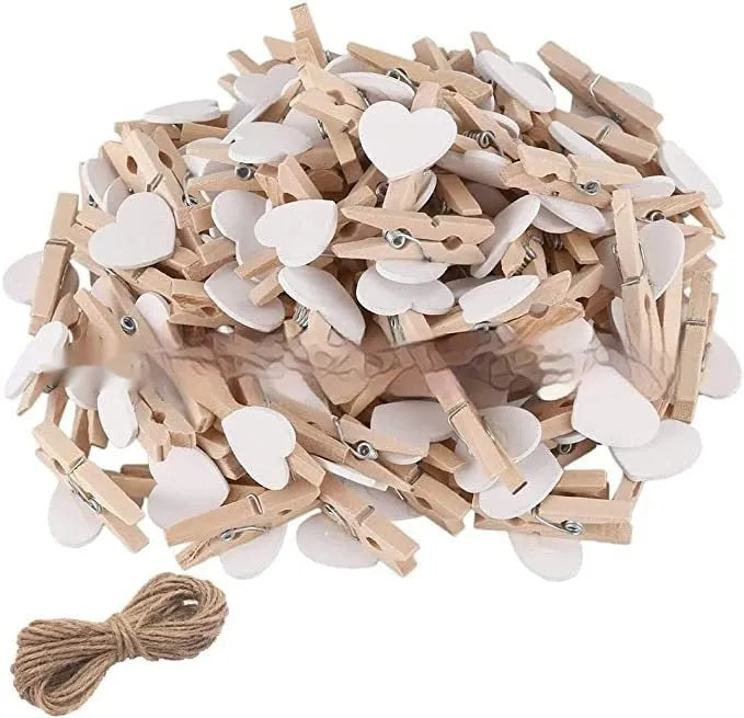 Set of five solid wood heart-shaped clips in red, white, and rose red on a plain surface.