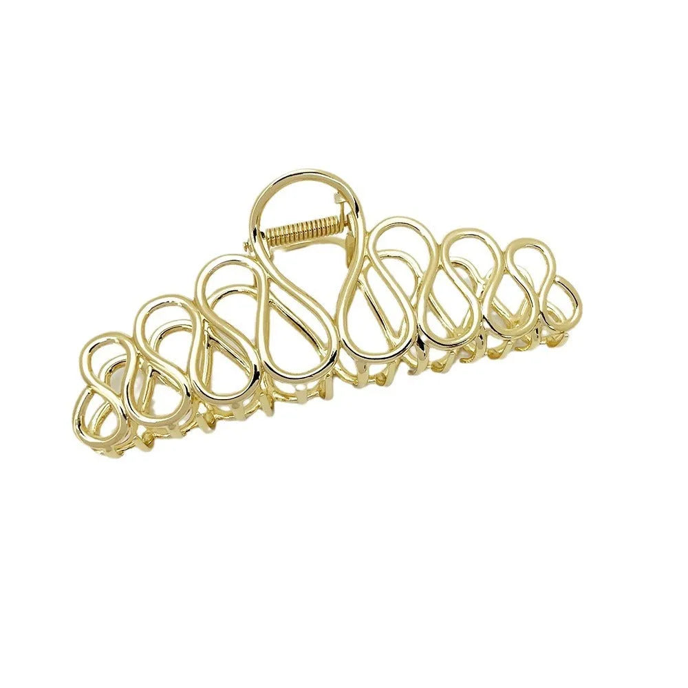 Minimalist large hair clip with electroplated finish and tassel detail.
