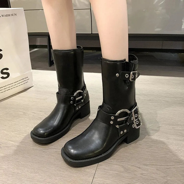 Women's black platform boots with belt buckle detail at mid-calf height