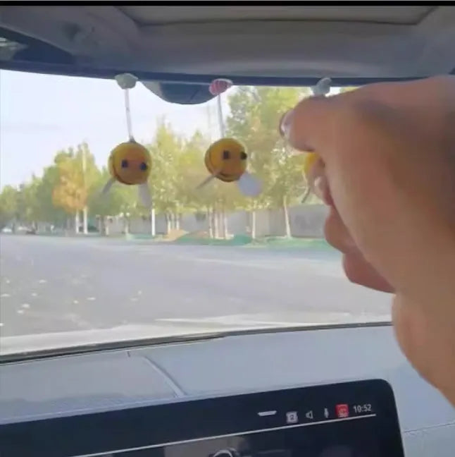 Cartoon-style little bee car decoration made from a soft fur ball, shown next to a ruler showing its 3cm size.