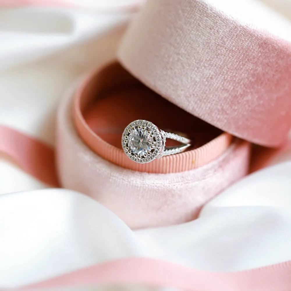 Silver ring with round rhinestone zircon centre on a plain background, women's affordable luxury style