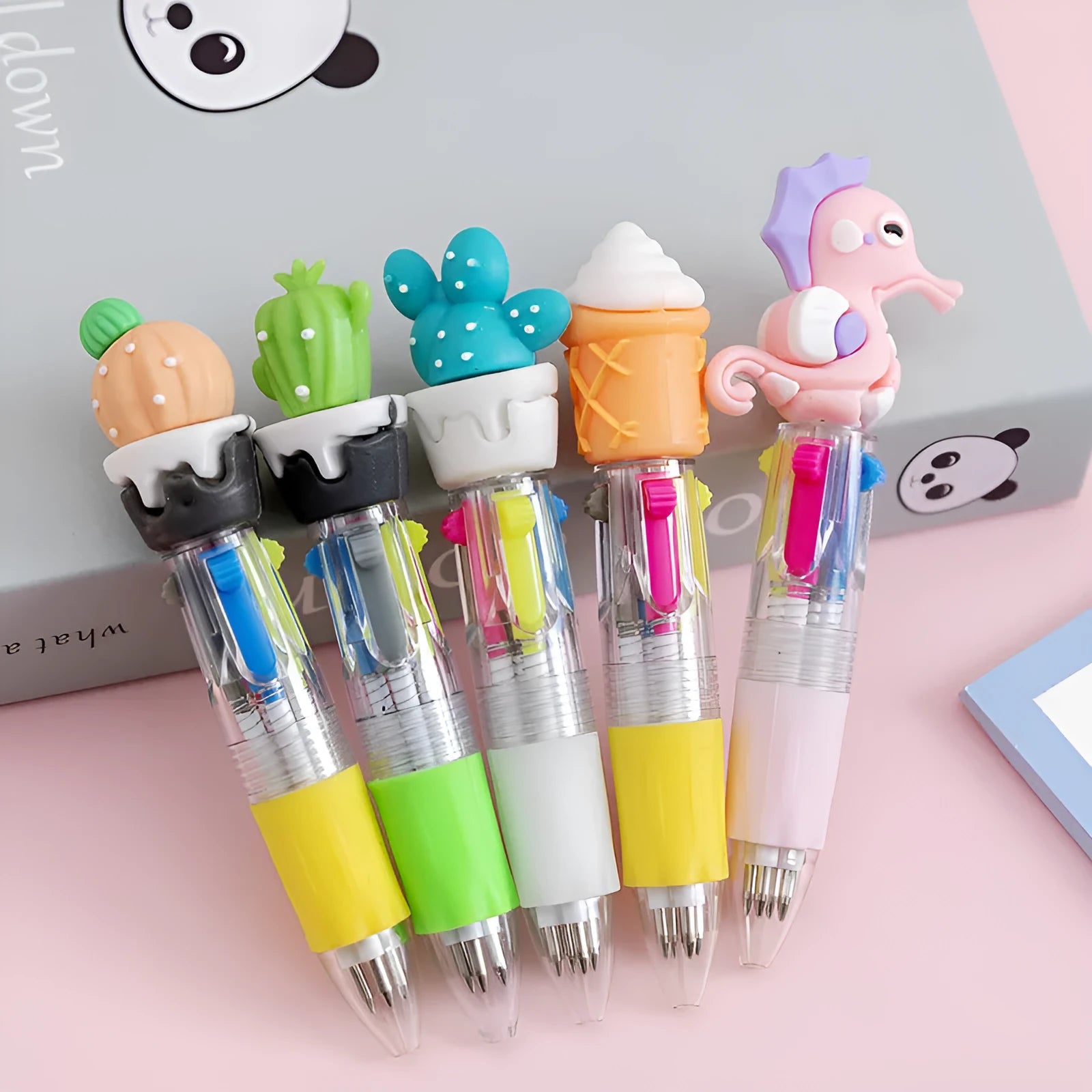 A four-colour press ballpoint pen with a cute cartoon design, showing a bullet-shaped 0.7mm writing tip.