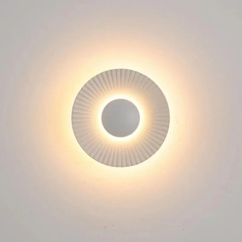 Round aluminium LED wall lamp in a choice of six colour finishes for bedroom or living room.