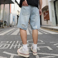 Light blue distressed denim shorts with straight leg cut and hip hop style on hanger