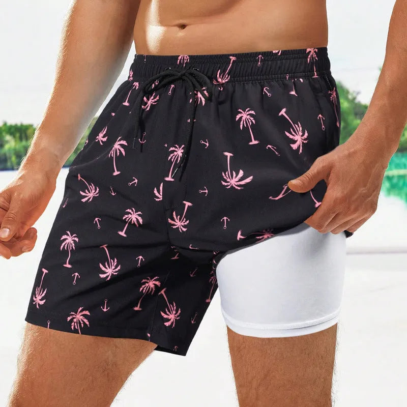 Men's loose quick-dry swimming trunks with floral pattern in green and blue colours