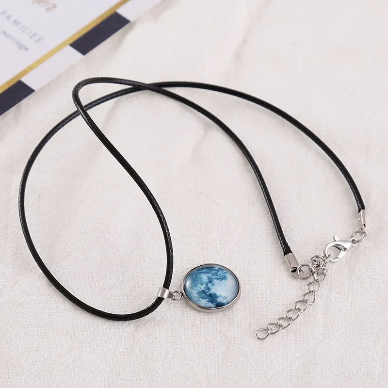 Luminous moon and constellation night sky pendant on an extendable alloy necklace chain.