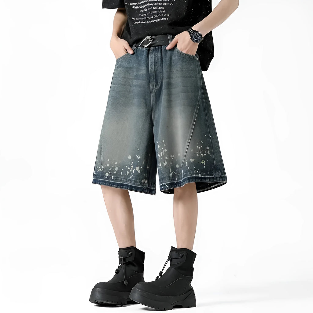 Retro blue denim shorts with distressed rip details and splash ink patterns, straight leg cut