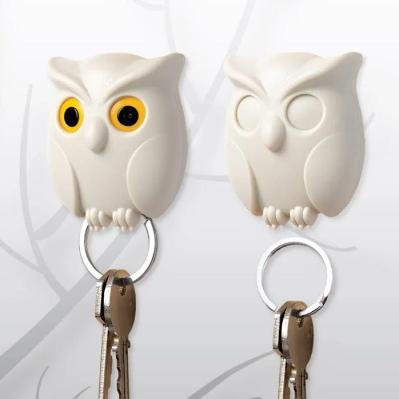Magnetic wall key holder in white with attached keychains on a wall surface