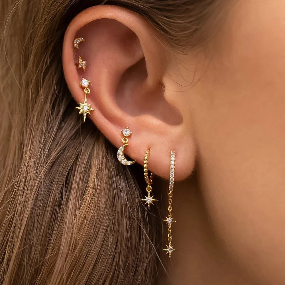 Six gold-colour chain tassel earrings with zircon detail arranged as a complete set