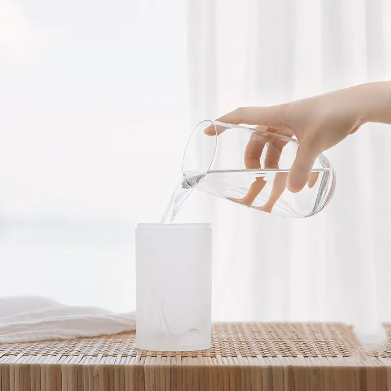 Columnar car USB humidifier in ice white with timer, placed in car cup holder