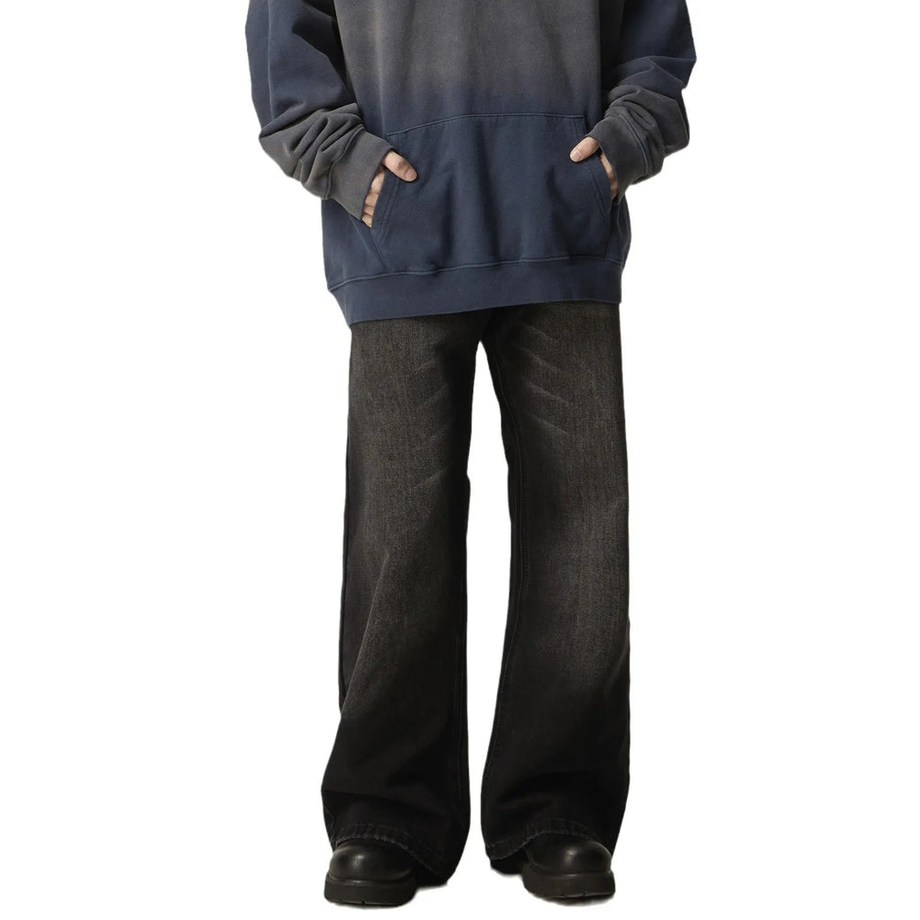 Black loose straight leg retro jeans on a hanger showing zipper fly detail